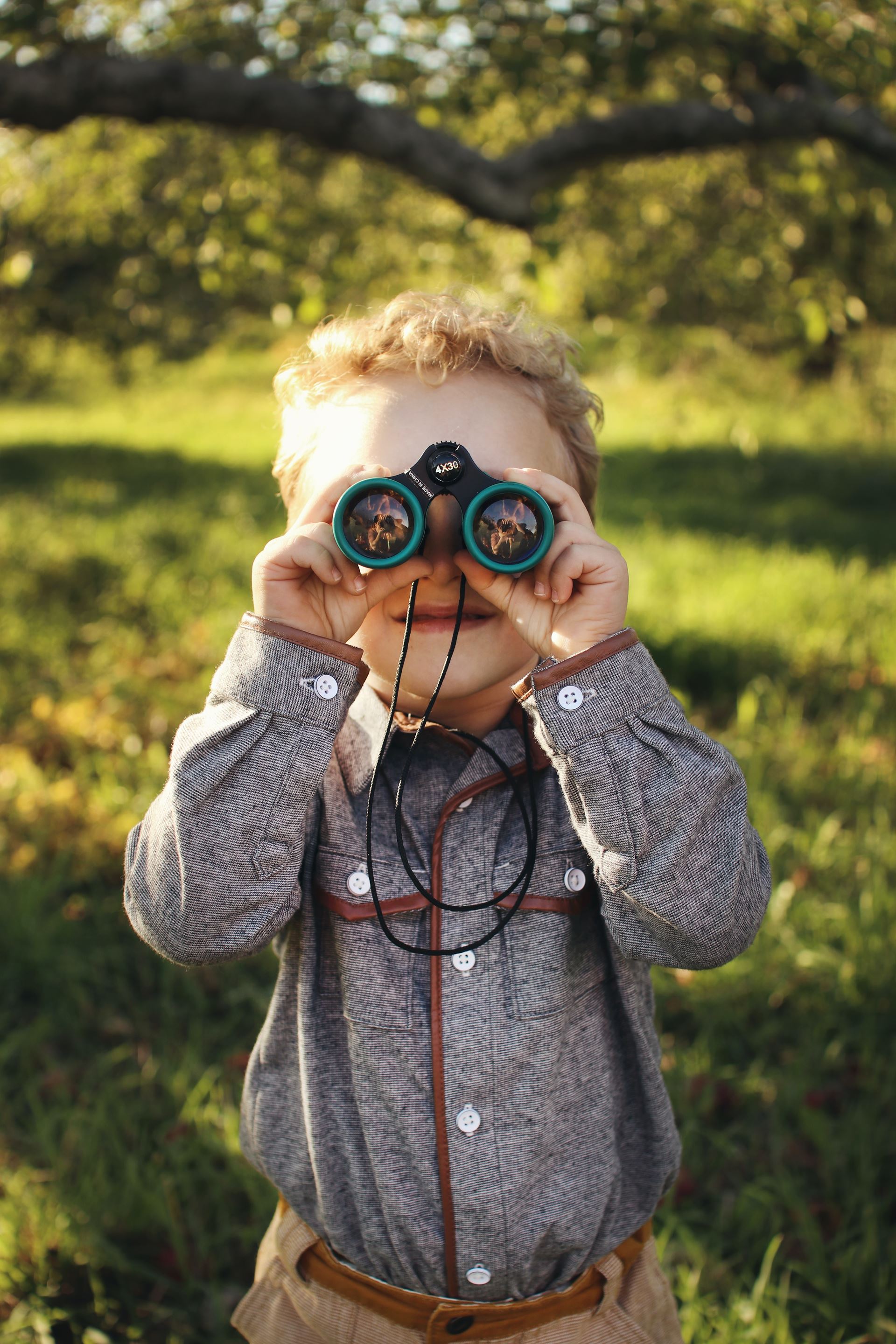 I child looking through binoculars